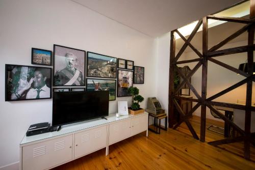 a living room with a flat screen tv on a white wall at Fanqueiros 204 - Old Town in Lisbon