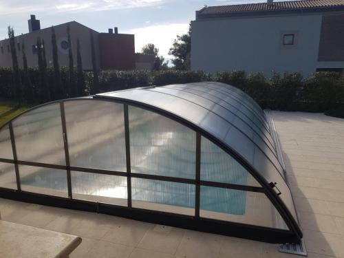 a glass greenhouse on top of a patio at Villen Matija & Mima in Fažana