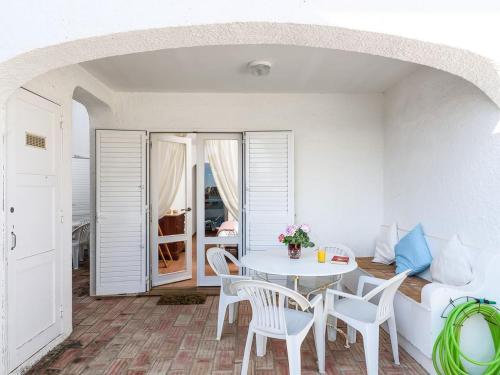 a dining room with a white table and chairs at Villa Luz Bay w Private Pool in Luz