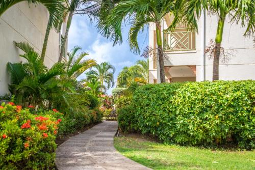 a walkway leading to a lush green garden at Bay Gardens Beach Resort & Spa in Gros Islet
