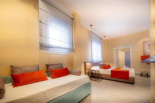 a bedroom with two beds and two windows at Casa Angelina in Marsala