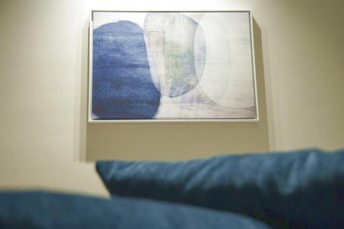 a picture hanging on a wall next to a couch at Casa Angelina in Marsala