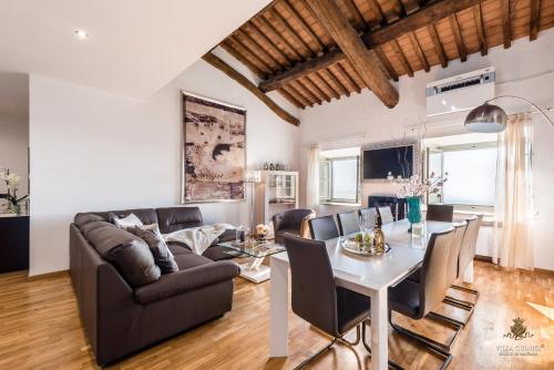 a living room with a couch and a table at Villa Guinigi Dimora di Epoca Exclusive Residence & Pool in Lucca