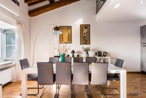 a dining room with a white table and chairs at Villa Guinigi Dimora di Epoca Exclusive Residence & Pool in Lucca
