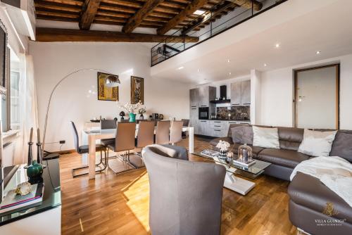 a living room with a couch and a table at Villa Guinigi Dimora di Epoca Exclusive Residence & Pool in Lucca