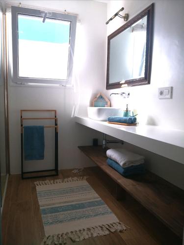 a bathroom with a sink and a mirror at Blu Oceano in Teguise