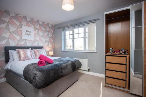 a bedroom with a large bed and a window at Wilton Lodge in Redcar