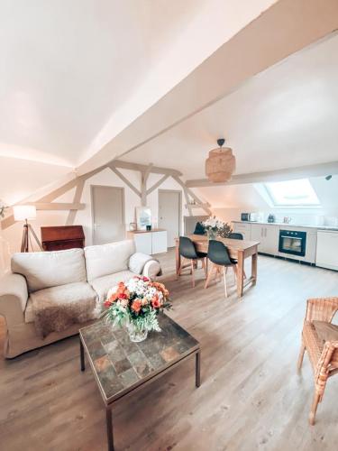 un salon avec un canapé et une table dans l'établissement Chambres Privées dans une maison de charme, à Saint-Brice-sous-Forêt