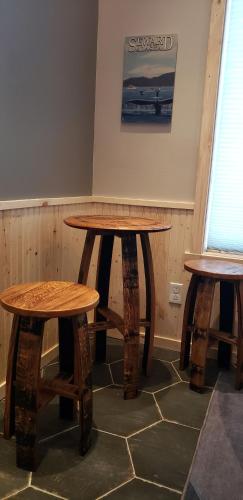 a wooden table and two stools in a room at Entire Tiny Home close to cruise ship terminal Alaska Railroad and downtown Seward in Seward