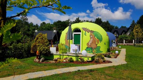 a tiny house in a garden in a yard at Chata w Rabce - Bajkowa Osada in Rabka