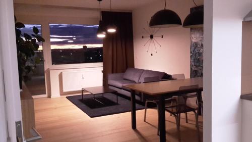 a living room with a table and a couch at Appartment Zentrum Wels in Wels