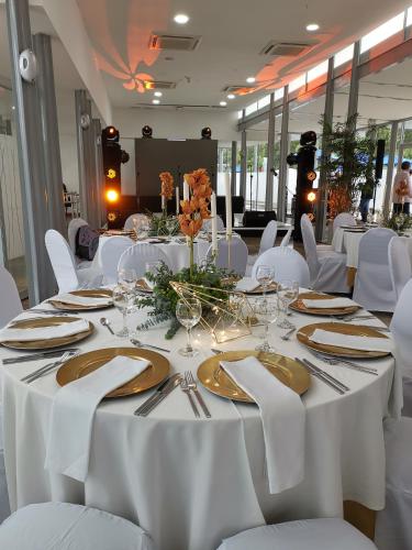 a dining room with white tables and white chairs at Hotel San Fernando Plaza in Medellín