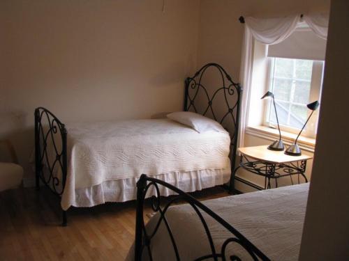a bedroom with two beds and a window at Tulloch Inn & Gifts in Inverness