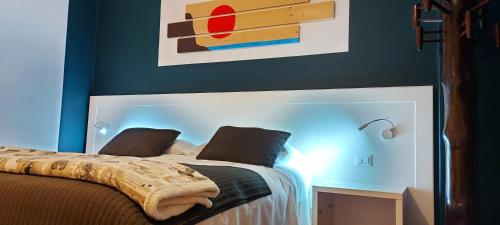 a bedroom with a bed with a blue wall at Casa Lady in Garda