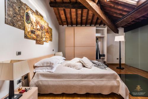 a bedroom with a large bed in a room at Villa Guinigi Dimora di Epoca Exclusive Residence & Pool in Lucca