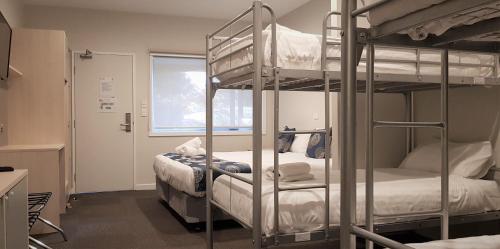 a room with two bunk beds and a window at Leumeah Lodge in Canberra