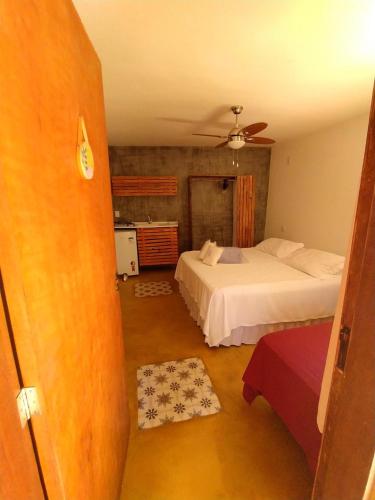 a bedroom with two beds and a ceiling at Maloca Hospedagem in Sao Jorge