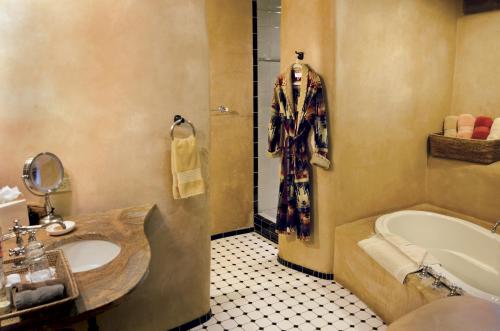 a bathroom with a sink and a bath tub at El Portal Sedona Hotel in Sedona