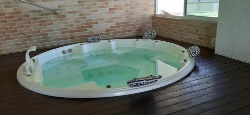 a large bath tub sitting on a wooden floor at Portamaris Resort Private Apartment 201 in Aquiraz