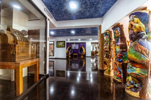a museum with lots of art on the walls at Hacienda del Valle Sagrado in Urubamba