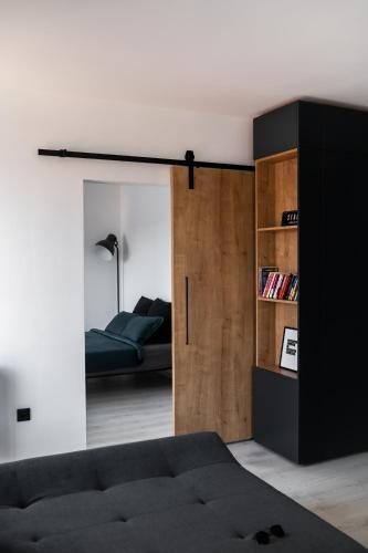 a room with a bed and a sliding glass door at Skylark - Manhattan Penthouse with Jacuzzi & Panoramic View in Braşov