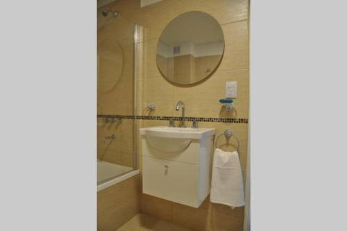 a bathroom with a sink and a mirror at La Amada in Puerto Madryn