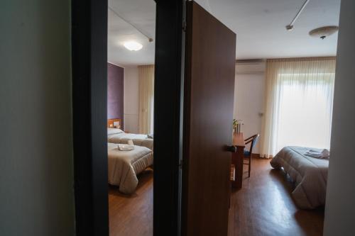 a hotel room with two beds and a room with a bed sqor at Hotel Tre Monti in Popoli