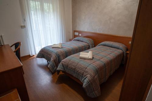 Postel nebo postele na pokoji v ubytování Hotel Tre Monti