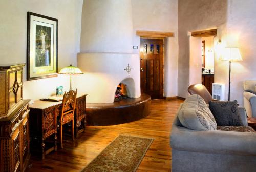 a living room with a couch and a fireplace at El Portal Sedona Hotel in Sedona