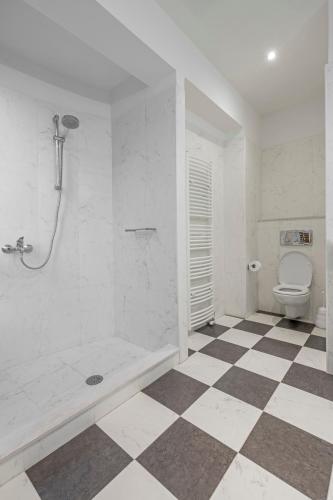 a white bathroom with a toilet and a shower at Anssami Villa in Rhodes Town