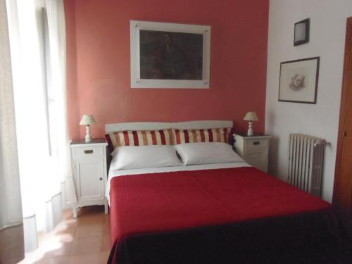 a red bedroom with a bed with two night stands at Hotel Morlacchi in Perugia