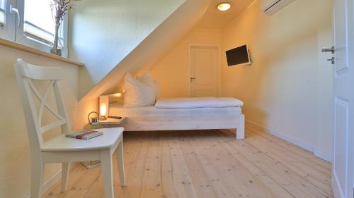 a small room with a bed and a staircase at Heideröschen Park Heideröschen 9b in Zingst
