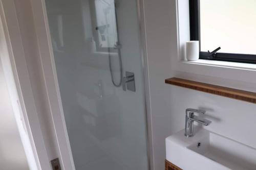 a bathroom with a shower and a sink at Big View from a Tiny House, Cashmere in Christchurch