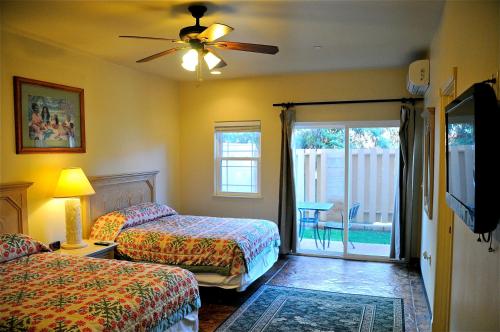 A bed or beds in a room at The West Inn Kauai