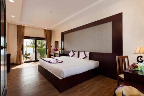 Postel nebo postele na pokoji v ubytování TTC Resort Ninh Thuan