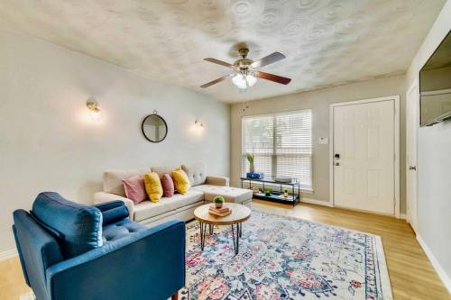 a living room with a couch and a ceiling fan at Global Cup Urban Relaxation 2 BR Apartment in Dallas
