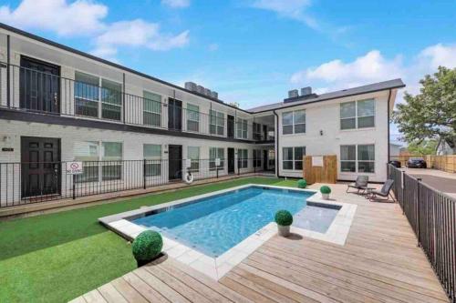 an exterior view of a house with a swimming pool at Global Cup Urban Relaxation 2 BR Apartment in Dallas