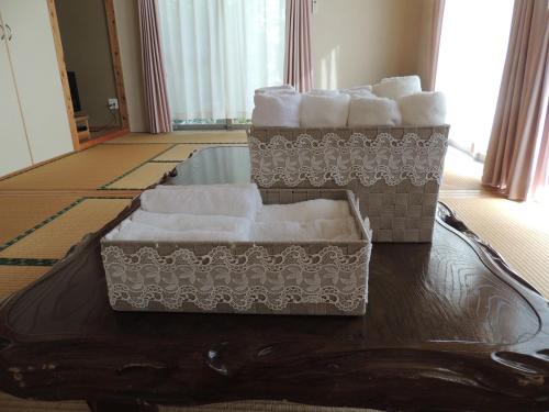 three boxes of towels are sitting on a table at びせ崎の宿　海潮音 in Motobu