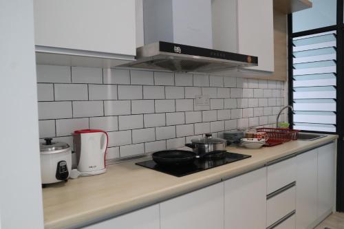 a kitchen counter with a stove top oven at Zen66 @ Roxy Serviced Apartment in Kuching