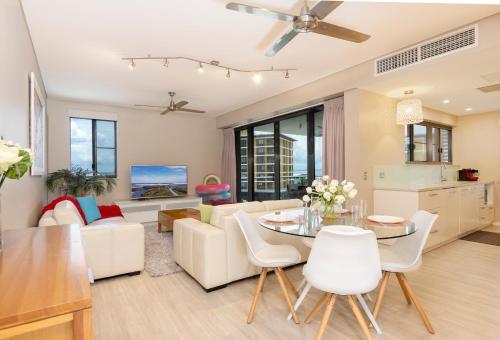 a living room with a couch and a table at Darwin Waterfront Luxury Suites in Darwin