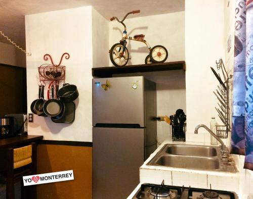 a small kitchen with a sink and a refrigerator at Departamento completo a pasos de Santa Lucia mty in Monterrey