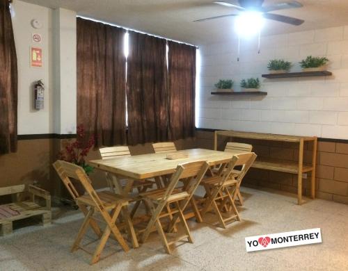 a dining room with a wooden table and chairs at Departamento completo a pasos de Santa Lucia mty in Monterrey