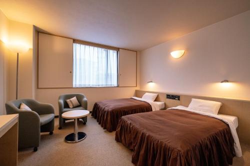 Postel nebo postele na pokoji v ubytování Chigusa Hotel