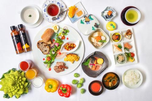 a white table with plates of food on it at Chigusa Hotel in Kitakyushu