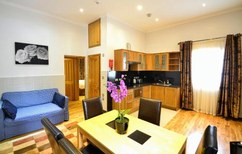 a living room with a table and a blue couch at Hyde Park Apartments in London