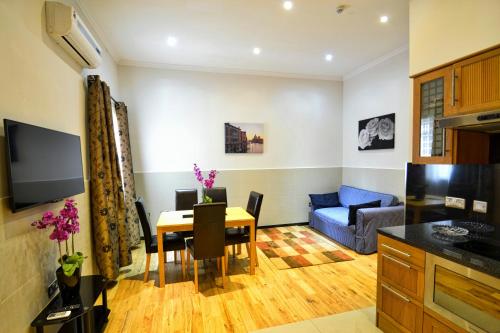 a living room with a table and a blue couch at Hyde Park Apartments in London