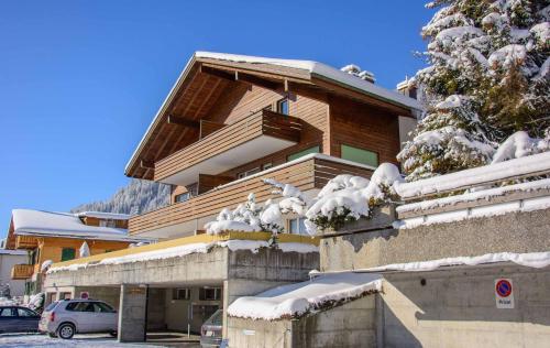 a building with snow on the side of it at Ferienwohnung Titschermatte in Adelboden