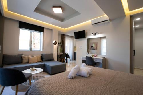 a bedroom with a bed and a living room at Αqua Dream Beach Apartment in Kos Town