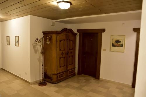 a room with a wooden cabinet and a door at Hotel Krone in Brunico