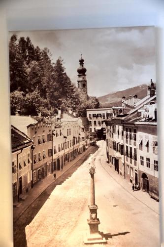 a black and white photo of a town with a clock tower at Hotel Krone in Brunico